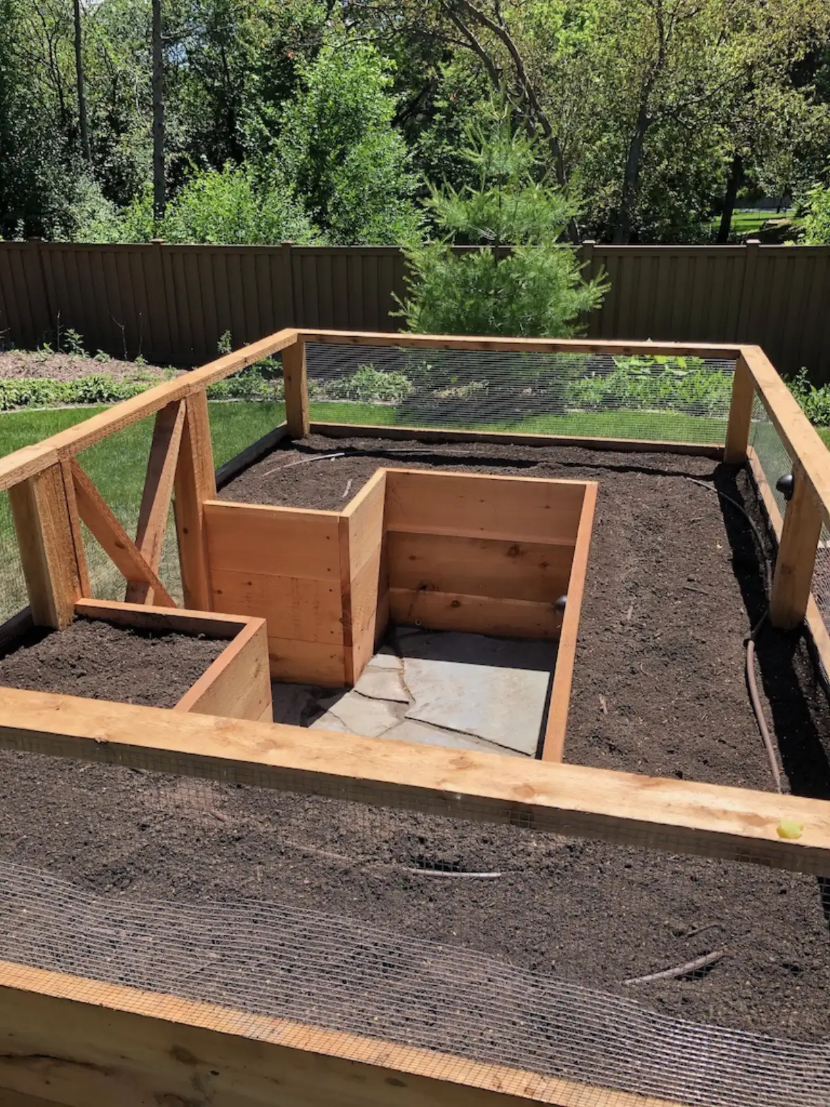 Fence with raised garden bed integration