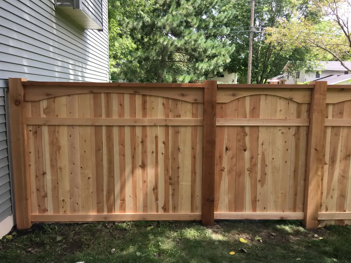Wood privacy gate beside a house