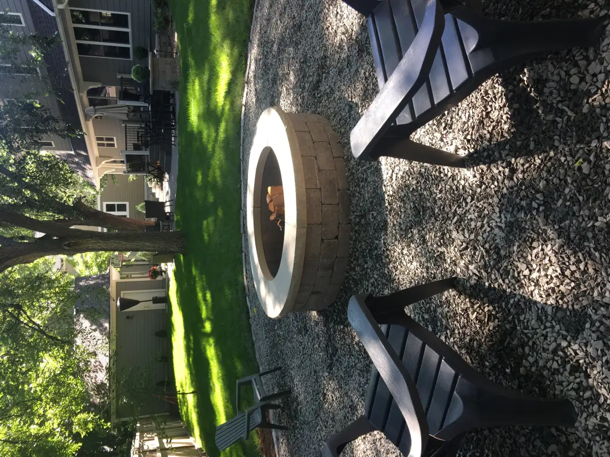 Fire pit with natural stone surround near Lake Minnetonka