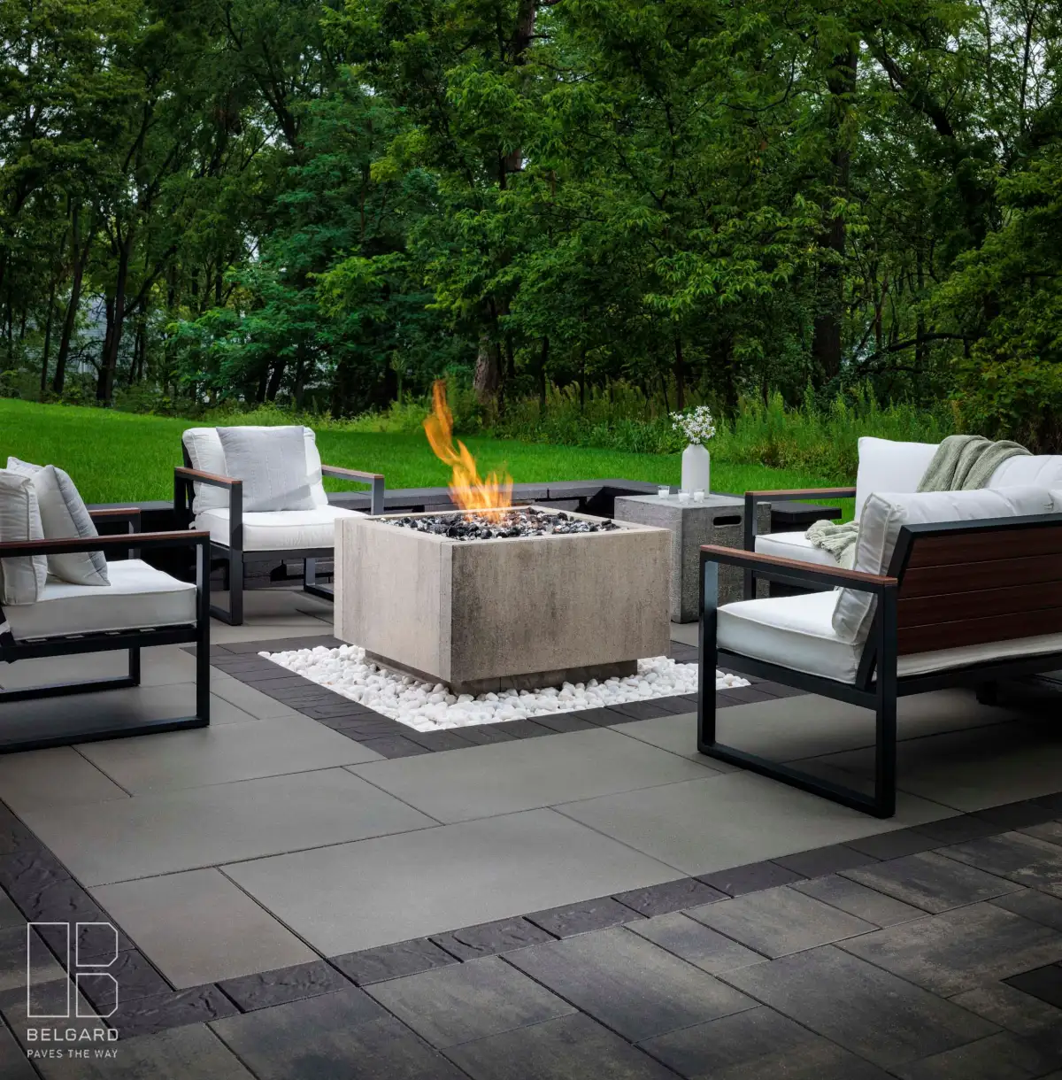 Estate tier Belgard patio with modern fire pit and lounge seating — $50-75K outdoor living project