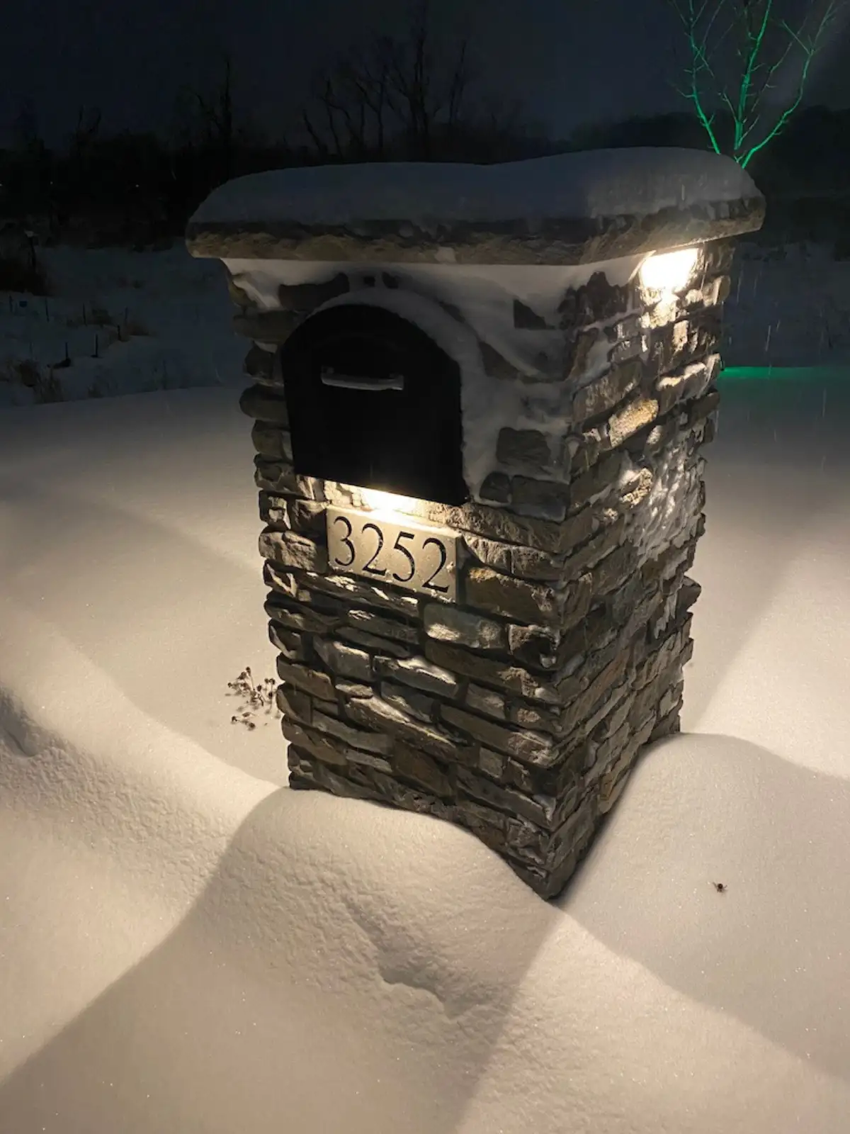 Low voltage LED landscape lighting on paver patio and retaining wall at dusk