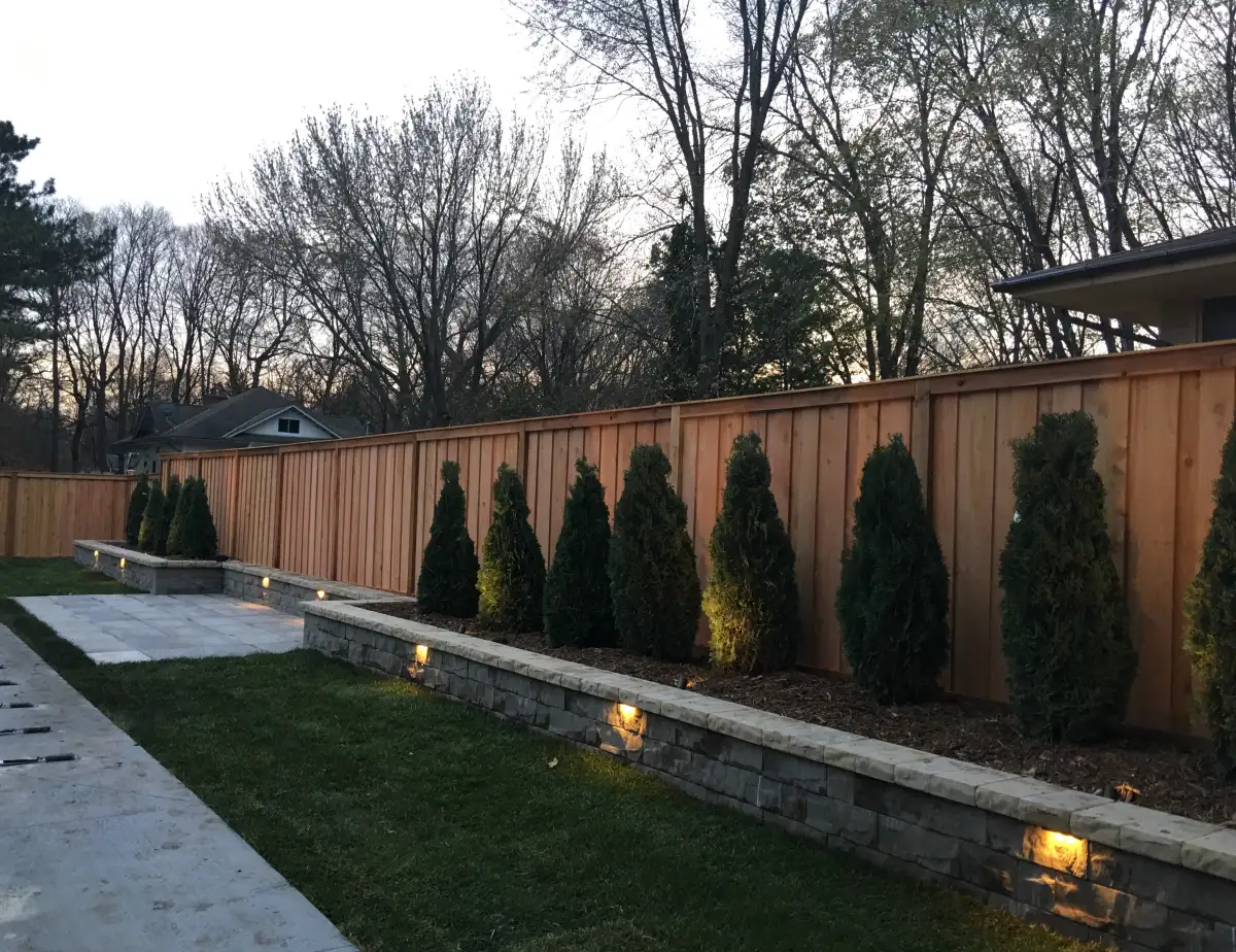 Outdoor lighting highlighting pergola and seating area after dark