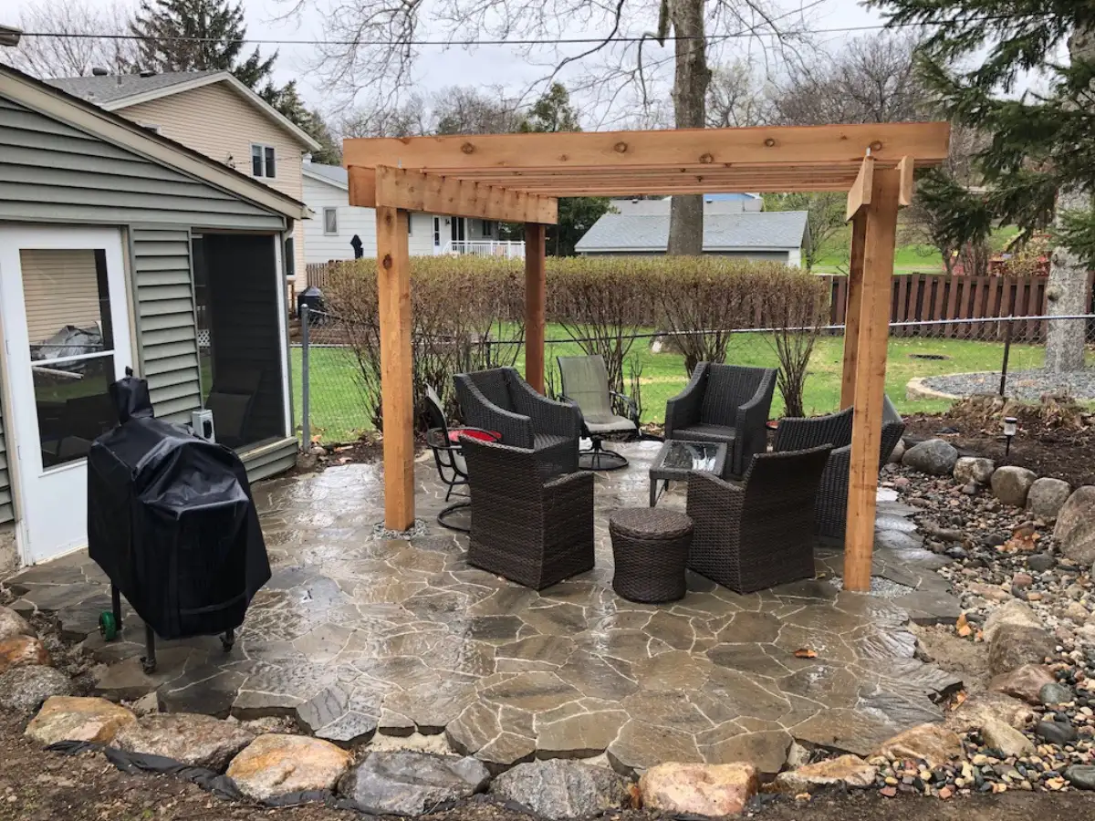 Custom pergola with integrated lighting over outdoor dining area