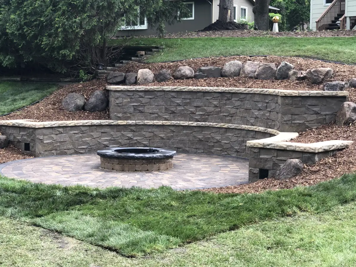 Retaining wall with integrated steps and landscape lighting